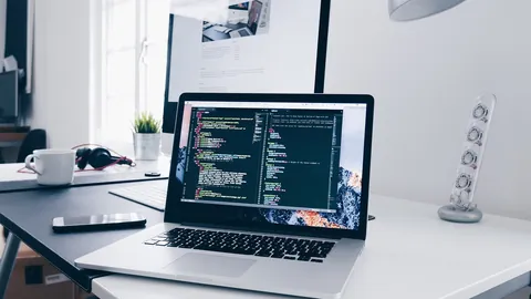 Laptop showing lines of code on a bright desk, a setting for practising SQL interview questions