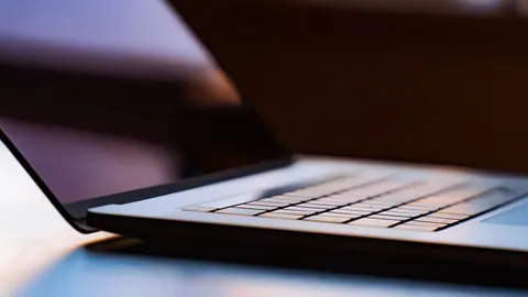 Close view of an open laptop keyboard in soft light, the everyday tool of software engineers